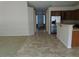 Open-concept area with tile floors leading to a kitchen with stainless steel appliances at 29797 W Mitchell Ave, Buckeye, AZ 85396