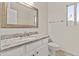Bright bathroom featuring a granite countertop, undermount sink, and framed mirror at 300 W Windsor Dr, Gilbert, AZ 85233