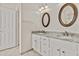Bathroom featuring dual vanities, granite countertops, framed mirrors, and a tiled floor at 300 W Windsor Dr, Gilbert, AZ 85233