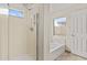 Bright bathroom featuring a shower, a tub, and a window for natural light at 300 W Windsor Dr, Gilbert, AZ 85233