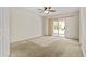 Spacious bedroom with carpet floors, ceiling fan, and sliding glass door leading to the backyard at 300 W Windsor Dr, Gilbert, AZ 85233