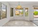 Cozy dining area with tiled floors and natural light from surrounding windows at 300 W Windsor Dr, Gilbert, AZ 85233