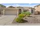 Charming single-story home with a well-manicured desert landscape and a two-car garage at 300 W Windsor Dr, Gilbert, AZ 85233