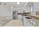 Bright kitchen with granite countertops, stainless steel appliances, and a tile backsplash at 300 W Windsor Dr, Gilbert, AZ 85233