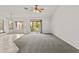 Open living room area with tiled floors and sliding glass door access to backyard at 300 W Windsor Dr, Gilbert, AZ 85233