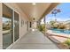 Covered patio with tile flooring, a ceiling fan, and views of the pool and landscaping at 300 W Windsor Dr, Gilbert, AZ 85233