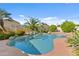 Private pool area with rock features, palm trees, and a well-maintained patio at 300 W Windsor Dr, Gilbert, AZ 85233