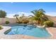 Inviting backyard pool with lush tropical landscaping and rock waterfall feature at 300 W Windsor Dr, Gilbert, AZ 85233