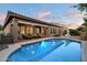 Private backyard oasis featuring pool, covered patio and lush landscaping at 3350 S Holguin Way, Chandler, AZ 85248