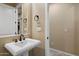 Neutral-toned bathroom featuring a pedestal sink and bronze fixtures at 3350 S Holguin Way, Chandler, AZ 85248