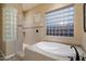 Luxurious bathroom with a soaking tub and walk-in shower with tiled surround at 3350 S Holguin Way, Chandler, AZ 85248