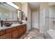 Stylish bathroom featuring dual sinks, granite countertops, and a walk-in shower at 3350 S Holguin Way, Chandler, AZ 85248