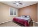 Cozy bedroom with plush carpet, window and ceiling fan at 3350 S Holguin Way, Chandler, AZ 85248