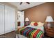 Comfortable bedroom with a colorful blanket, closet, ensuite access, and warm, neutral color scheme at 3350 S Holguin Way, Chandler, AZ 85248