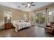 Bright bedroom with hardwood floors, shutters, and private patio access at 3350 S Holguin Way, Chandler, AZ 85248