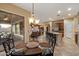 Bright dining room with patio access, chandelier, and views of the kitchen and living space at 3350 S Holguin Way, Chandler, AZ 85248