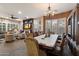 Elegant dining room with chandelier adjacent to a comfortable living area with fireplace at 3350 S Holguin Way, Chandler, AZ 85248