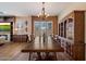Elegant dining room with a large wooden table, traditional hutch, chandelier lighting, and views of the cozy living area at 3350 S Holguin Way, Chandler, AZ 85248