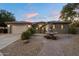 Charming home exterior with fountain, well-maintained landscaping, and a two-car garage at 3350 S Holguin Way, Chandler, AZ 85248