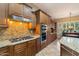 Gourmet kitchen with granite countertops, modern appliances, and ample cabinet space for storage at 3350 S Holguin Way, Chandler, AZ 85248