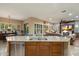 Well-designed kitchen with stainless steel appliances and an island, flows into the living area at 3350 S Holguin Way, Chandler, AZ 85248