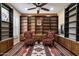 Inviting library space with large built-in bookshelves, a patterned rug, comfortable seating and bright, natural lighting at 3350 S Holguin Way, Chandler, AZ 85248