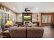 Inviting living room with a cozy fireplace, built-in entertainment center, plantation shutters and comfortable seating area at 3350 S Holguin Way, Chandler, AZ 85248