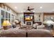 Comfortable living room featuring a cozy fireplace, built-in shelving, and ample seating at 3350 S Holguin Way, Chandler, AZ 85248