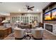 Spacious living room featuring a fireplace, custom built-ins, and large windows with plantation shutters at 3350 S Holguin Way, Chandler, AZ 85248
