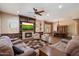 Open-concept living room featuring a fireplace with built-ins and views into the dining area with elegant chandelier at 3350 S Holguin Way, Chandler, AZ 85248