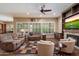 Spacious living room with hardwood floors, fireplace, large windows with plantation shutters, and comfortable seating arrangement at 3350 S Holguin Way, Chandler, AZ 85248