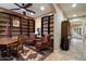 Cozy home office with bookshelves, patterned chairs, a decorative rug and wood accents at 3350 S Holguin Way, Chandler, AZ 85248