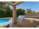 Outdoor kitchen area with stainless steel grill and countertop space by pool at 3350 S Holguin Way, Chandler, AZ 85248