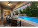 Relaxing outdoor patio with comfortable seating overlooking a sparkling pool and lush landscaping at 3350 S Holguin Way, Chandler, AZ 85248