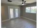 A bright bedroom with access to the patio and ceiling fan at 3538 W Sierra Vista Dr, Phoenix, AZ 85019