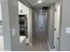 Hallway featuring hardwood flooring, neutral walls, and stainless steel appliances at 3538 W Sierra Vista Dr, Phoenix, AZ 85019