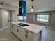 Bright kitchen featuring a large island with cooktop, stainless steel appliances, a range hood, and ample natural light at 3538 W Sierra Vista Dr, Phoenix, AZ 85019