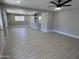Bright open-concept living room featuring hardwood flooring connected to the kitchen with breakfast bar seating at 3538 W Sierra Vista Dr, Phoenix, AZ 85019