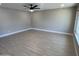 Bright living room featuring hardwood flooring, neutral walls, modern ceiling fan, and trim work at 3538 W Sierra Vista Dr, Phoenix, AZ 85019