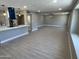 Bright open-concept living room featuring hardwood flooring, connected kitchen, and neutral walls at 3538 W Sierra Vista Dr, Phoenix, AZ 85019