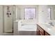Bright bathroom featuring a soaking tub with a shower at 35397 N Shorthorn Trl, San Tan Valley, AZ 85143