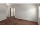 Bedroom with neutral carpet and three doors at 35397 N Shorthorn Trl, San Tan Valley, AZ 85143