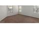 A clean and simple bedroom with carpet and three windows at 35397 N Shorthorn Trl, San Tan Valley, AZ 85143