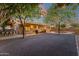 Expansive backyard with a covered patio, mature trees, and ample space for outdoor activities at 3842 W Ironwood Dr, Chandler, AZ 85226