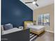 This bedroom features two beds, a large window for natural light, and an accent wall for a touch of color at 3842 W Ironwood Dr, Chandler, AZ 85226