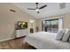 Comfortable bedroom with wood flooring and access to the backyard patio at 3842 W Ironwood Dr, Chandler, AZ 85226