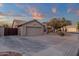 Tan home with a two car garage and desert landscaping in front on a paved street at 3842 W Ironwood Dr, Chandler, AZ 85226