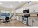 Well-lit kitchen area with white cabinets, granite countertops, and stainless steel appliances at 3842 W Ironwood Dr, Chandler, AZ 85226