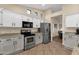 Bright kitchen with tile floors, stainless steel appliances, granite counters and an adjacent dining area at 3842 W Ironwood Dr, Chandler, AZ 85226