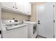 This laundry room includes a washer, dryer, white cabinets and neutral walls for a clean look at 3842 W Ironwood Dr, Chandler, AZ 85226